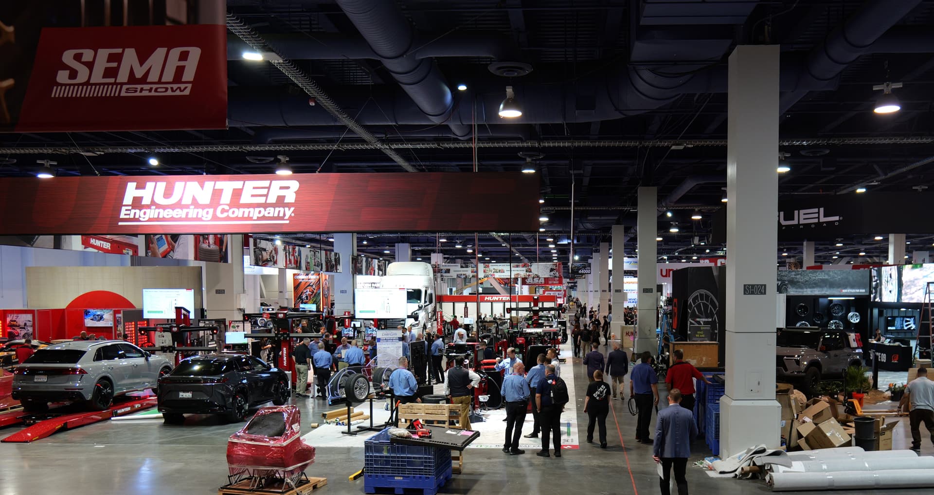 The SEMA Show 2025 floor in Las Vegas, with exhibitors and visitors in the aisles